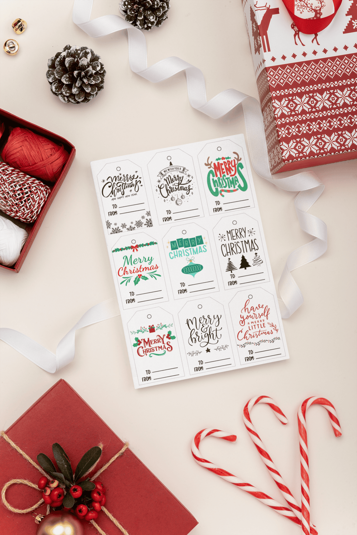 Festive holiday gift tags with cheerful designs like 'Merry Christmas' and 'Merry & Bright,' styled with Christmas decor including pinecones, candy canes, and a red-wrapped gift.