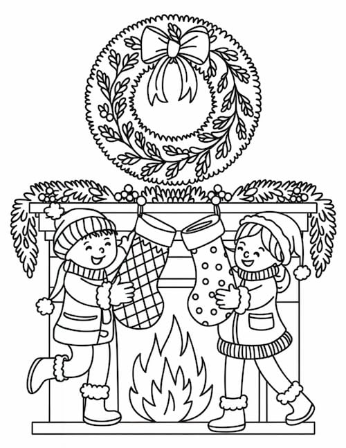  two children hanging stockings on a decorated fireplace, topped with a wreath and greenery.